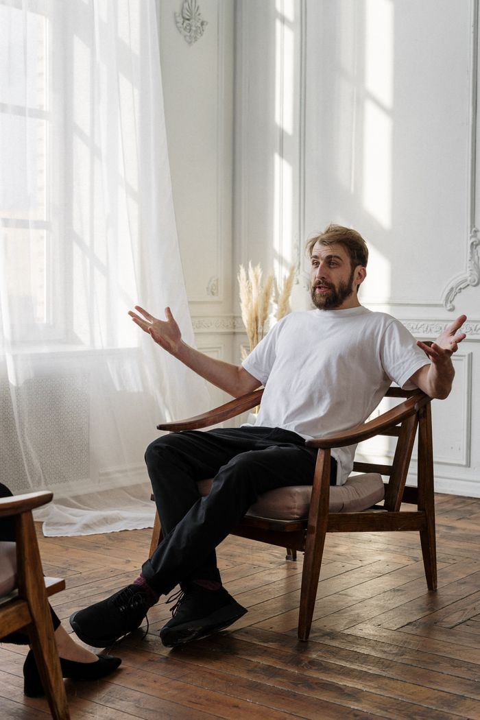 Crafting Captivating Headlines: Your awesome post title goes here A therapist discusses with a patient in a bright, sunlit room for a mental health session.