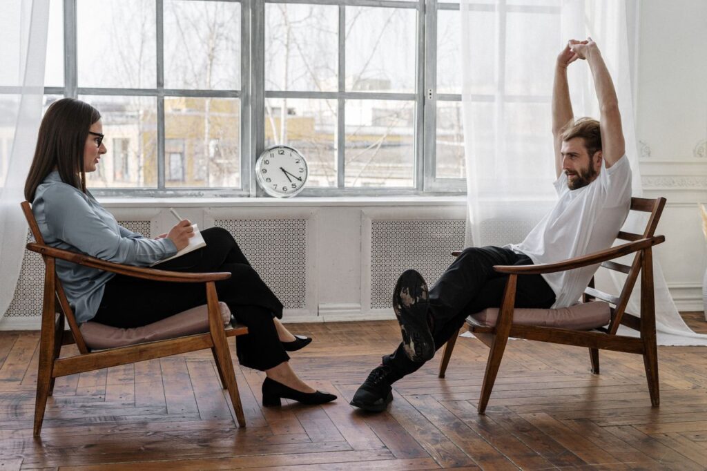 The Art of Drawing Readers In: Your attractive post title goes here A counselor and client engaged in a therapy session indoors, reflecting on emotions and solutions.