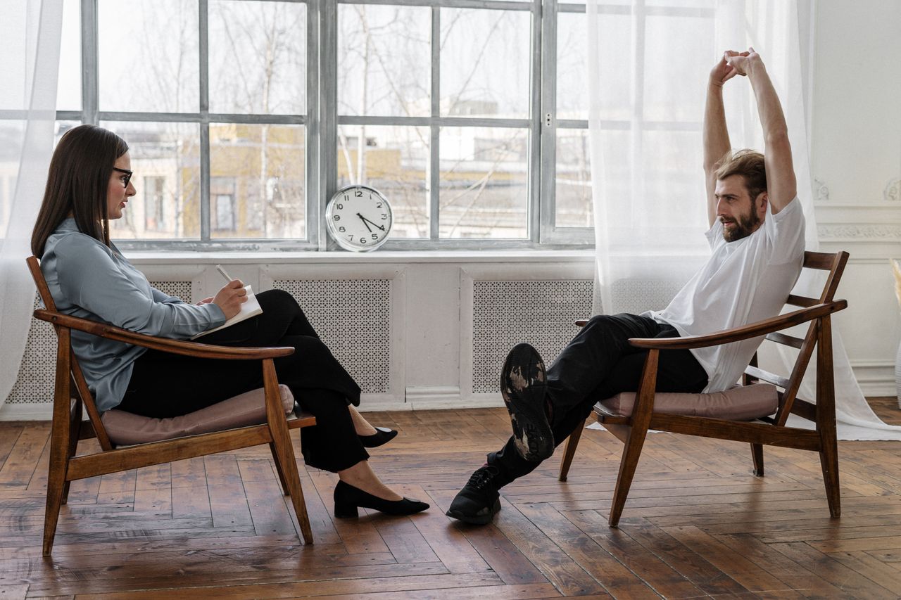 The Art of Drawing Readers In: Your attractive post title goes here A counselor and client engaged in a therapy session indoors, reflecting on emotions and solutions.